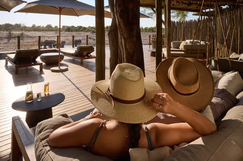 Guests relaxing on the deck at Savute Safari Lodge