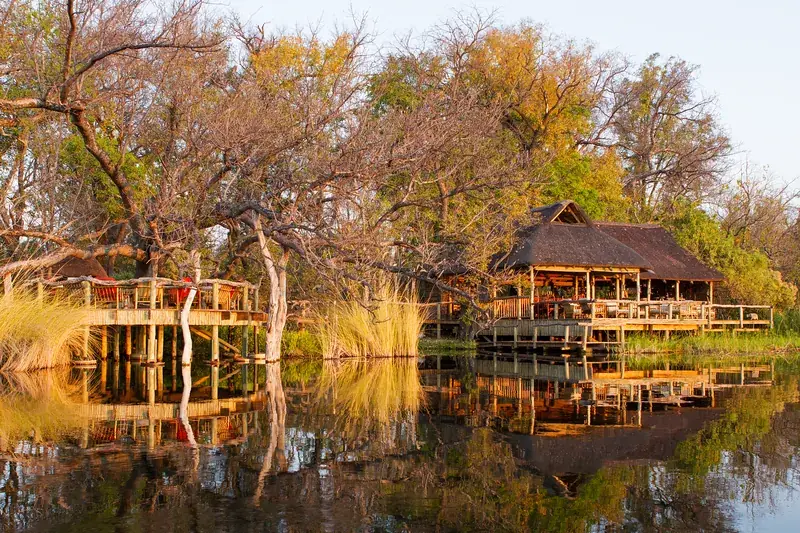Camp Xakanaxa’s thatched main building over the water in Moremi Game Reserve