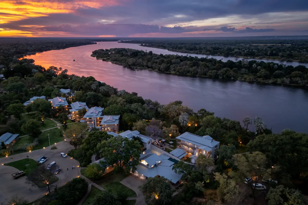 Aerial view of The Palm River Hotel at sunset over the Zambezi River